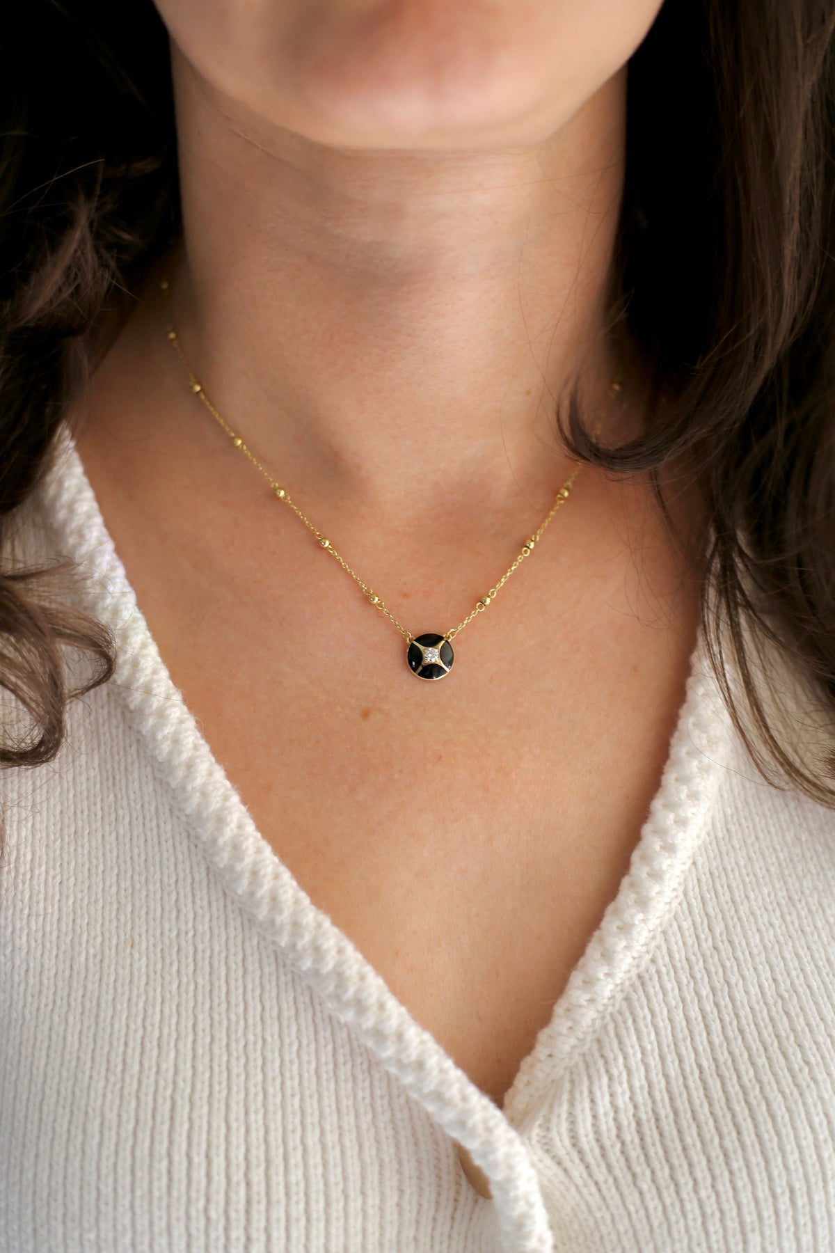 Black enamel and gold necklace with a 0.10ct lab diamond, fourth view