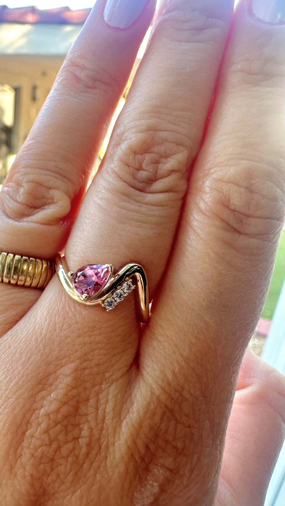 14K yellow gold wave ring with a pear shaped center stone, another angle