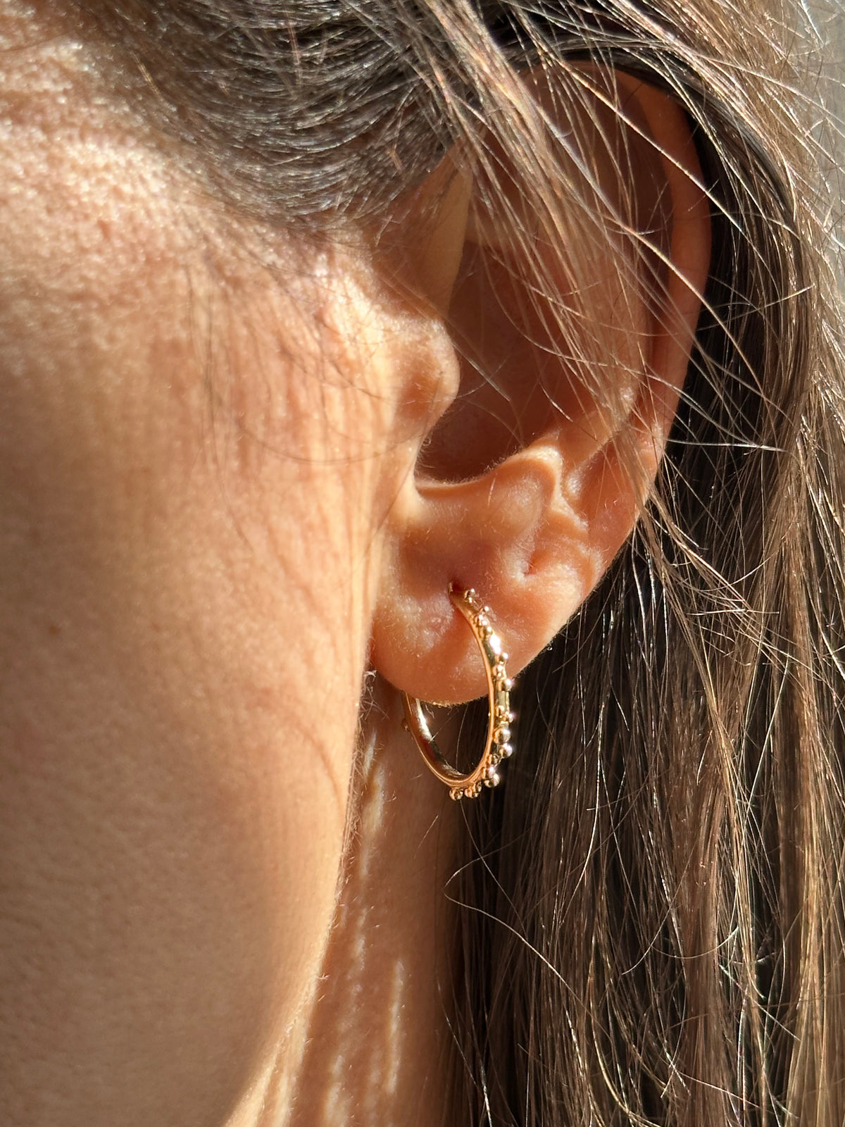 Gold hoop earring, a further view of the granule detailing