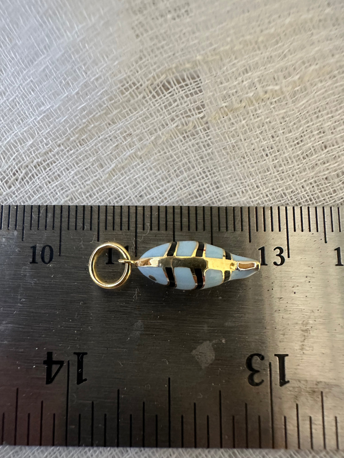 18K gold fish charm with black and light blue enamel, third view