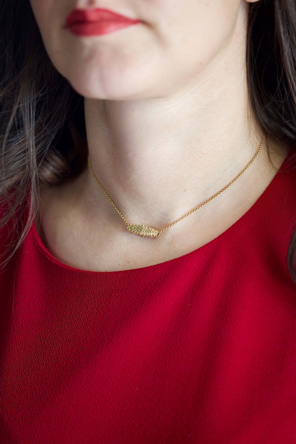 Gold slider pendant with a raw, unfinished organic surface