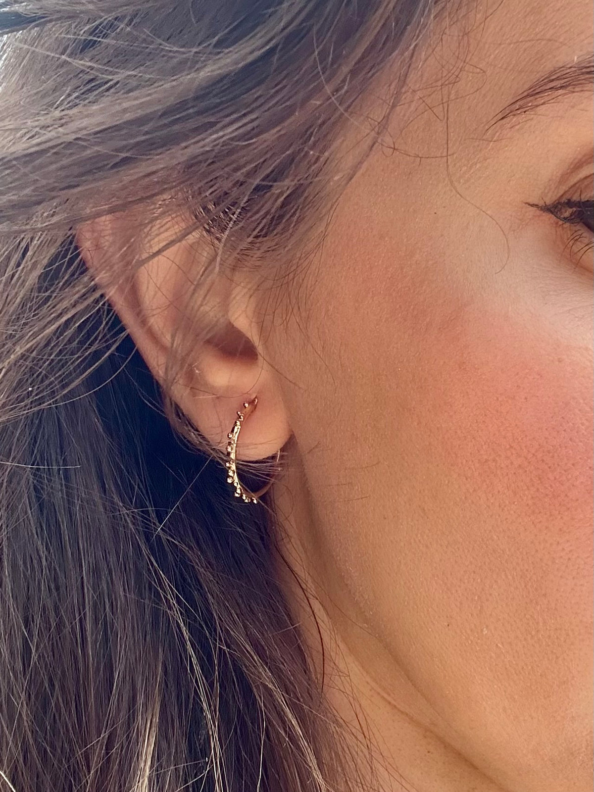 Gold hoop earrings, a 16mm round hoop shown from another angle
