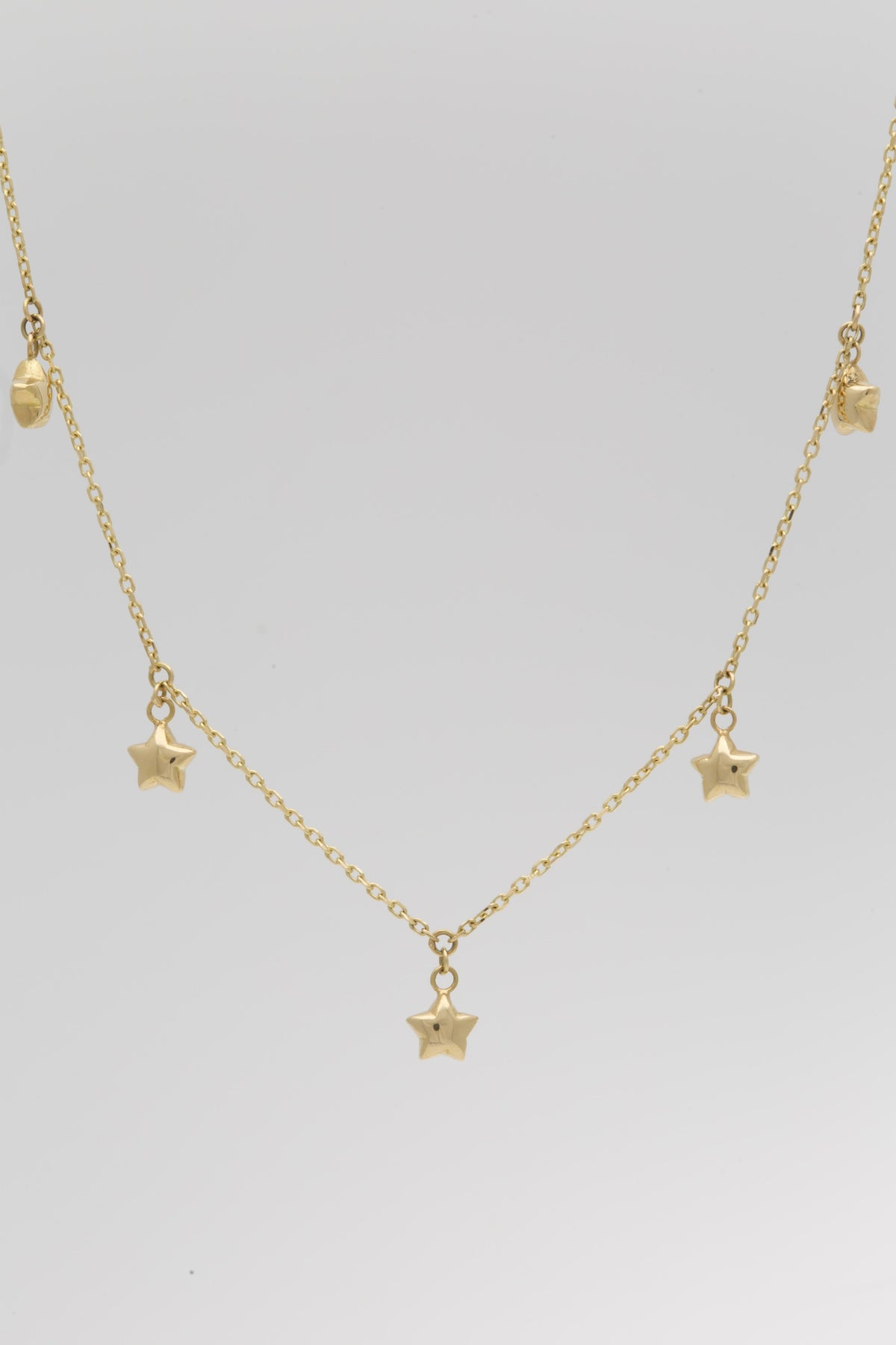 Five puffy star charms on a fine 18K solid gold chain | Yasmin Nabulsi Fine Jewelry