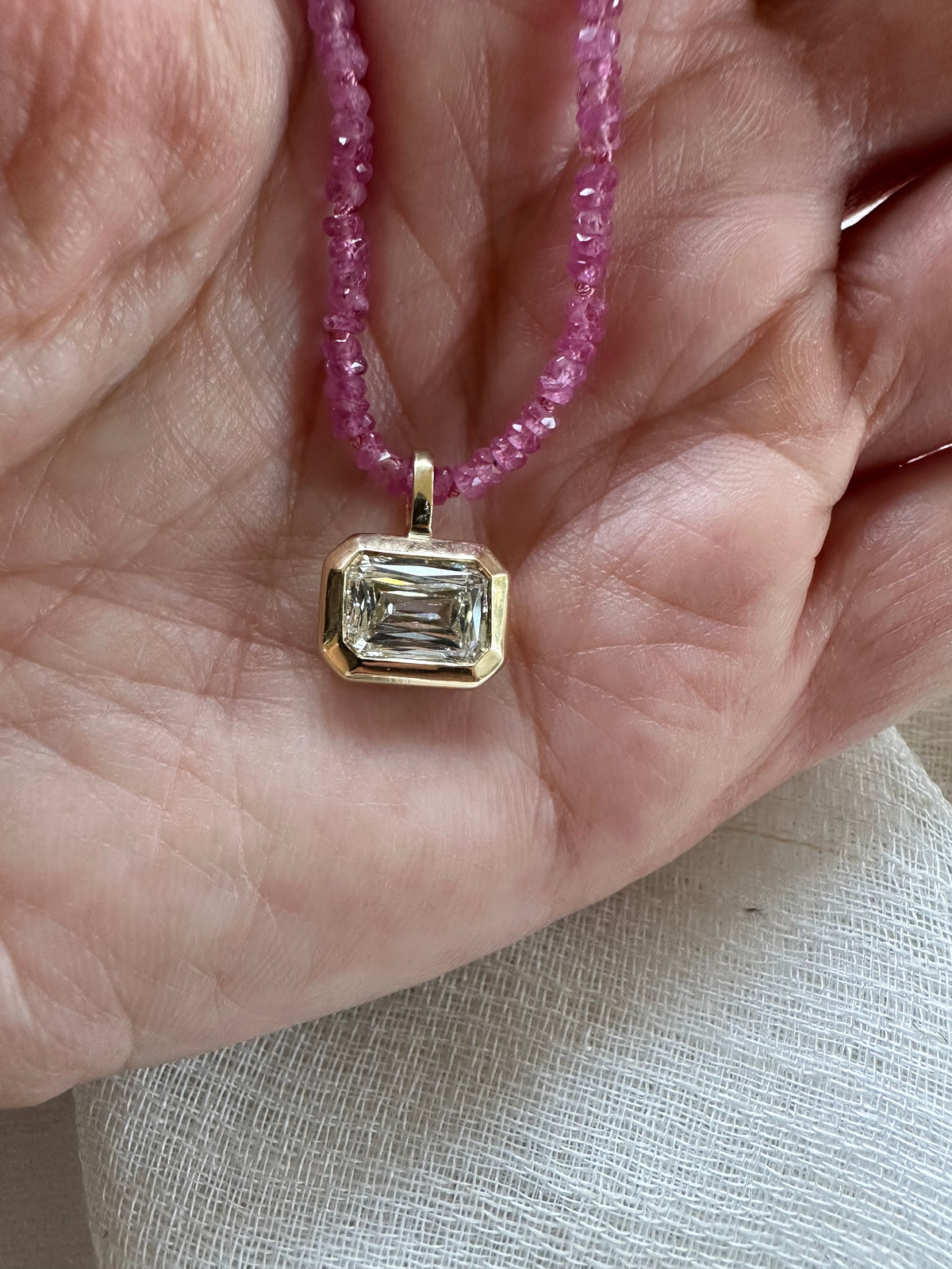 Pink sapphire beaded necklace with a knot after every 5 beads for strength
