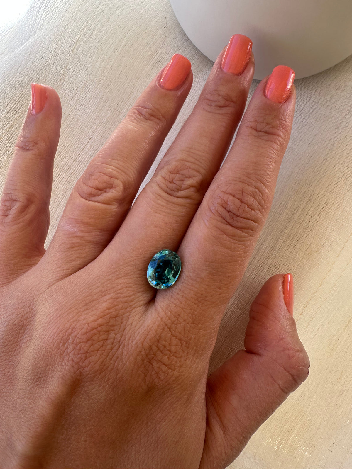 Blue zircon gemstone weighing 4.99 carats, listed as natural