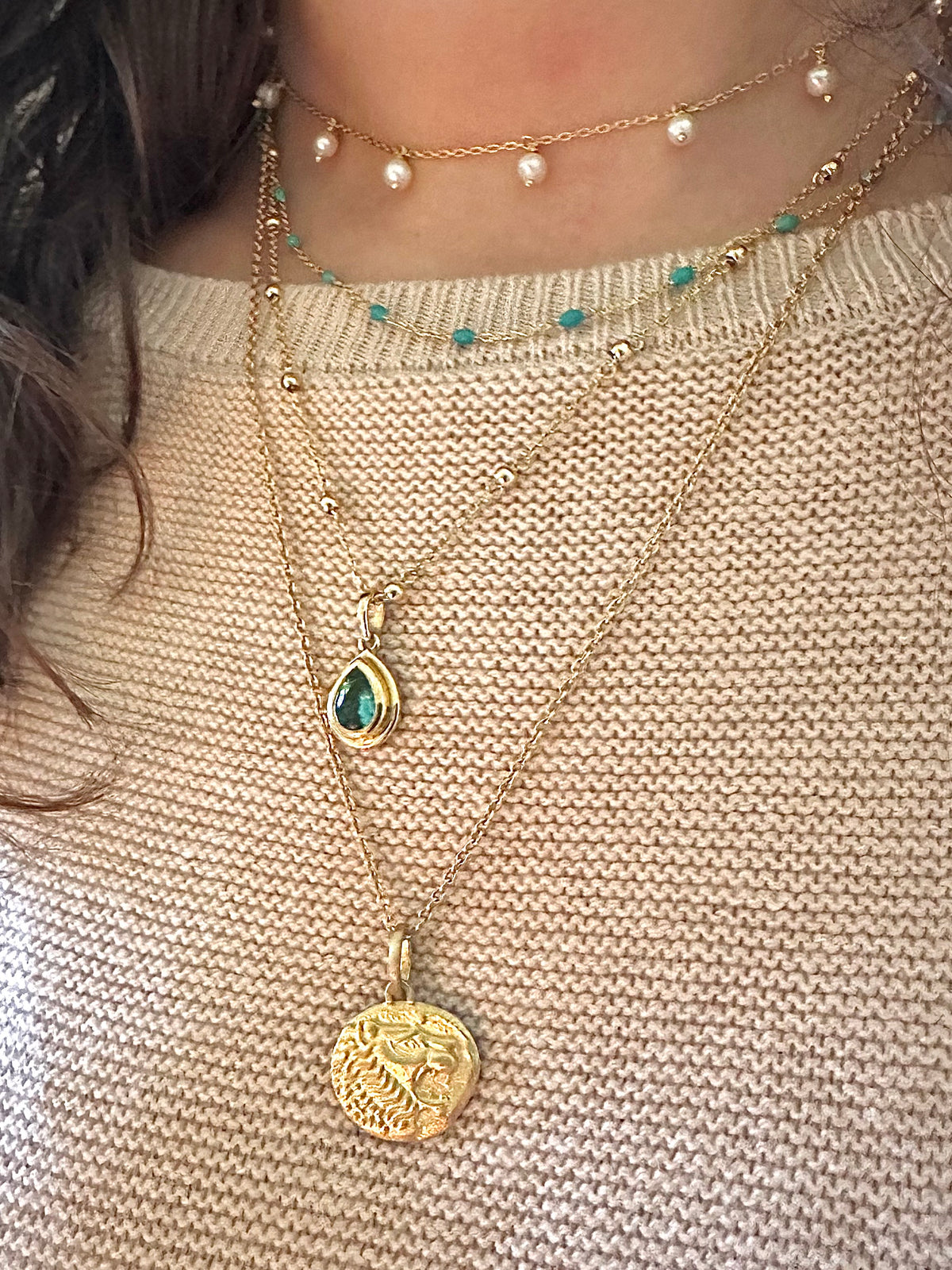 Gold lion coin pendant with a brushed finish, meant to pair with any chain