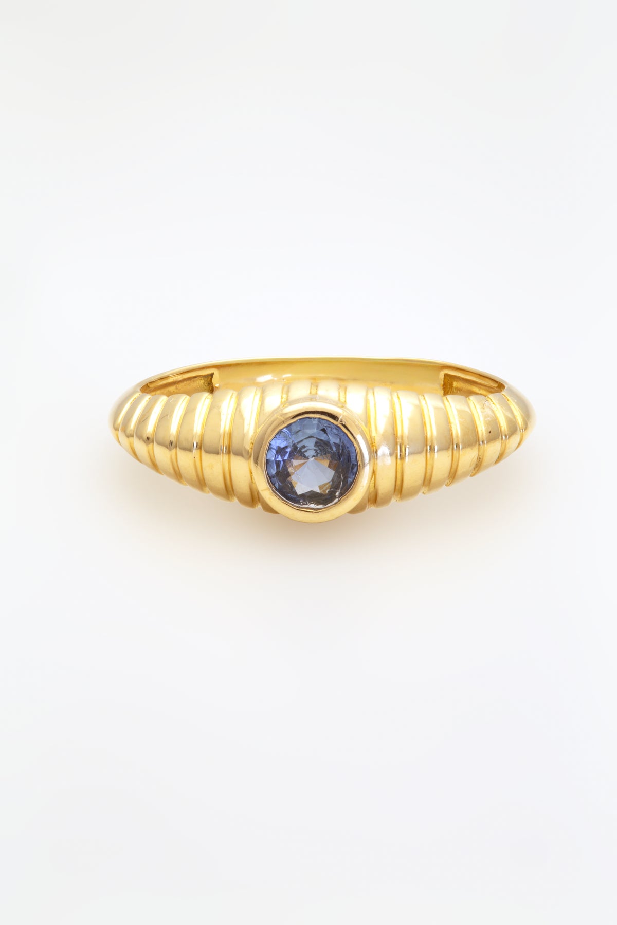Custom made blue sapphire ring with a bezel set center stone and ribbed band | Yasmin Nabulsi Fine Jewelry