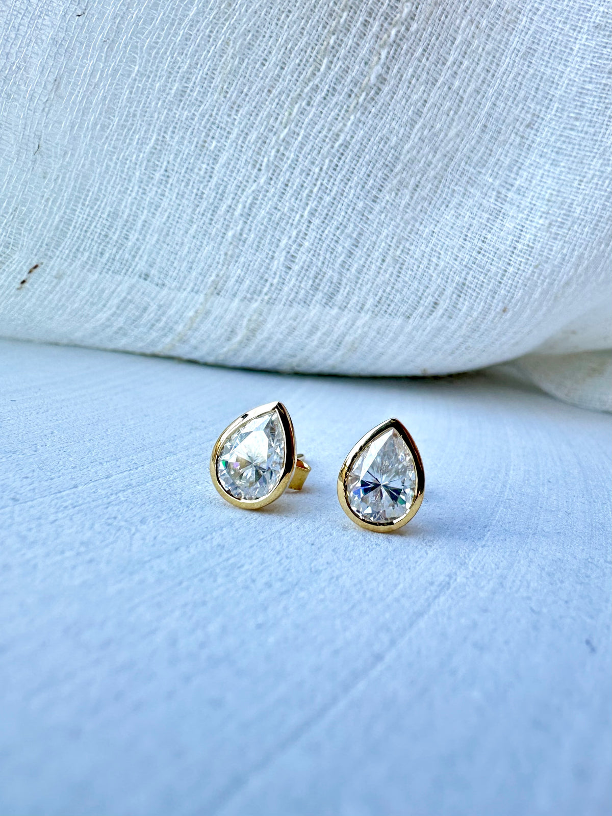 Pear moissanite stud earrings in an 18 karat gold bezel | Yasmin Nabulsi Fine Jewelry