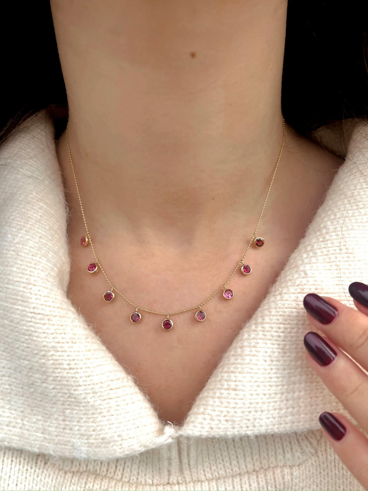 Pink tourmaline station necklace in solid 18K gold, worn on the neckline