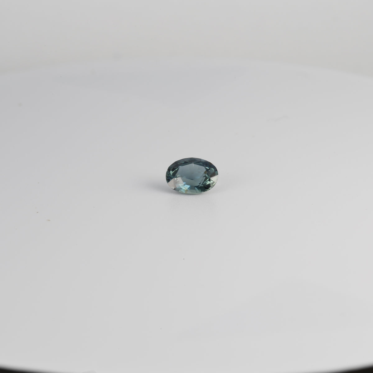 Teal sapphire mixed oval gemstone, 0.73ct, angle view