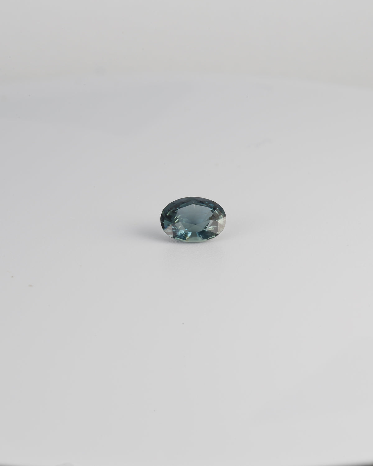 Mixed oval unheated teal sapphire, 6.3 by 4.8 mm