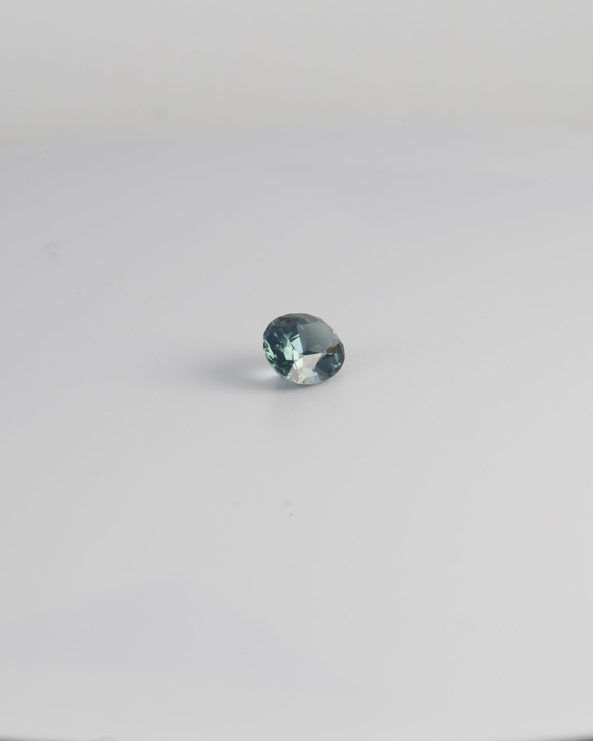 Teal sapphire gemstone, mixed oval cut, alternate angle
