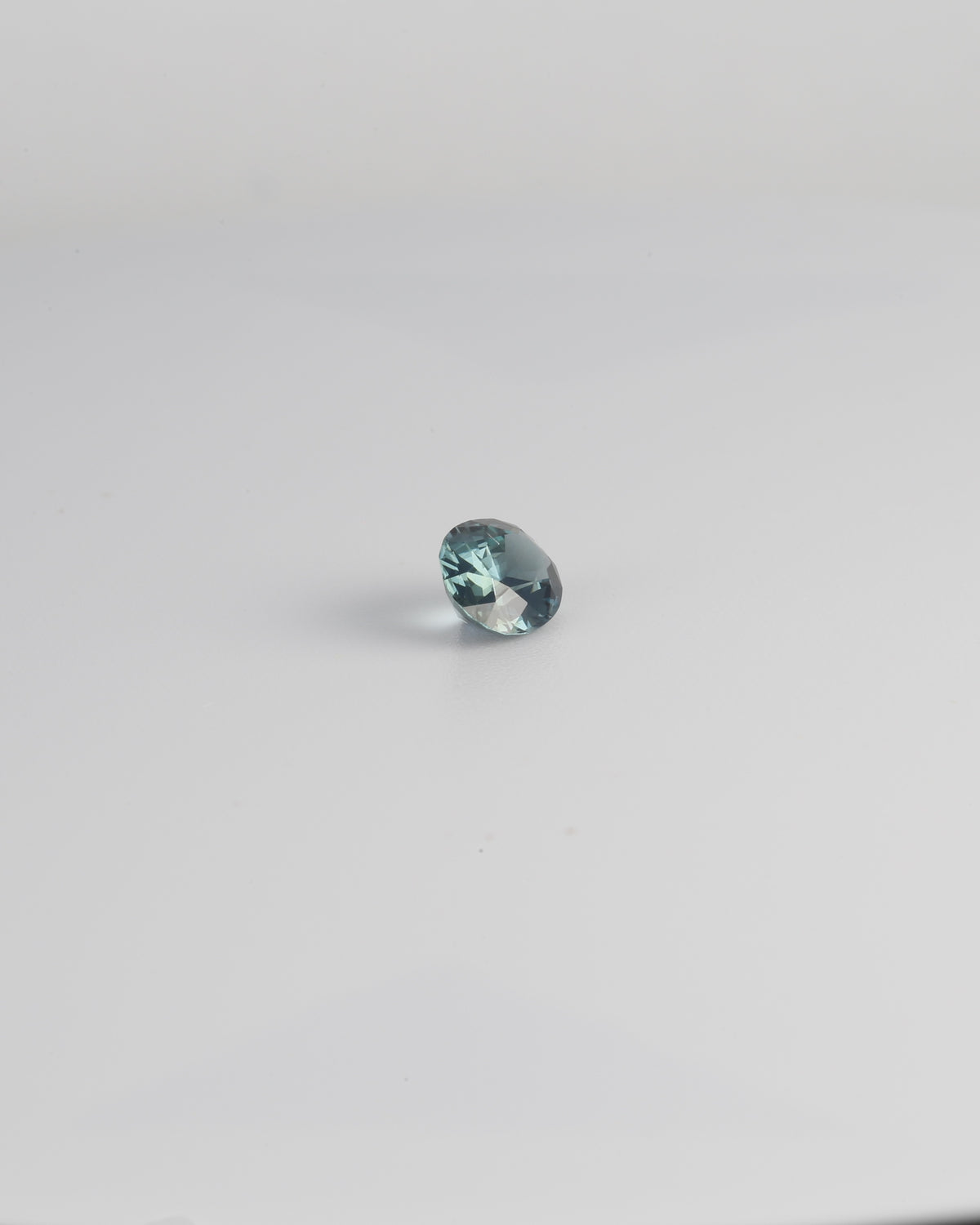 Natural teal sapphire gemstone, mixed oval cut, 0.73 carat