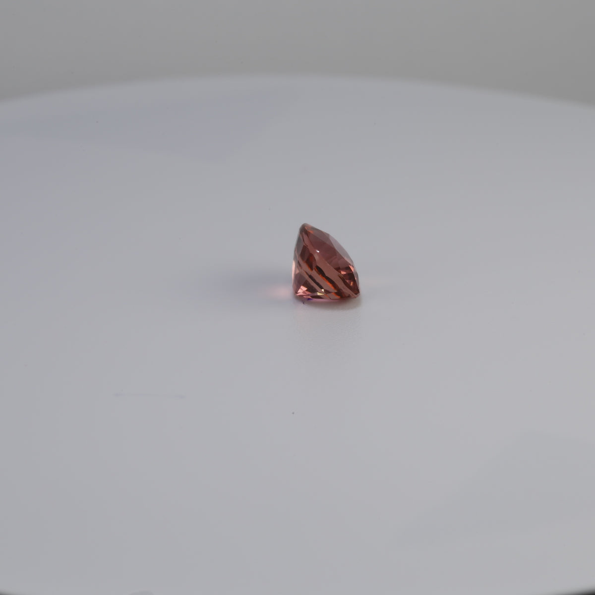 Pinkish peach tourmaline cushion cut gemstone, 1.42 carats, angled view