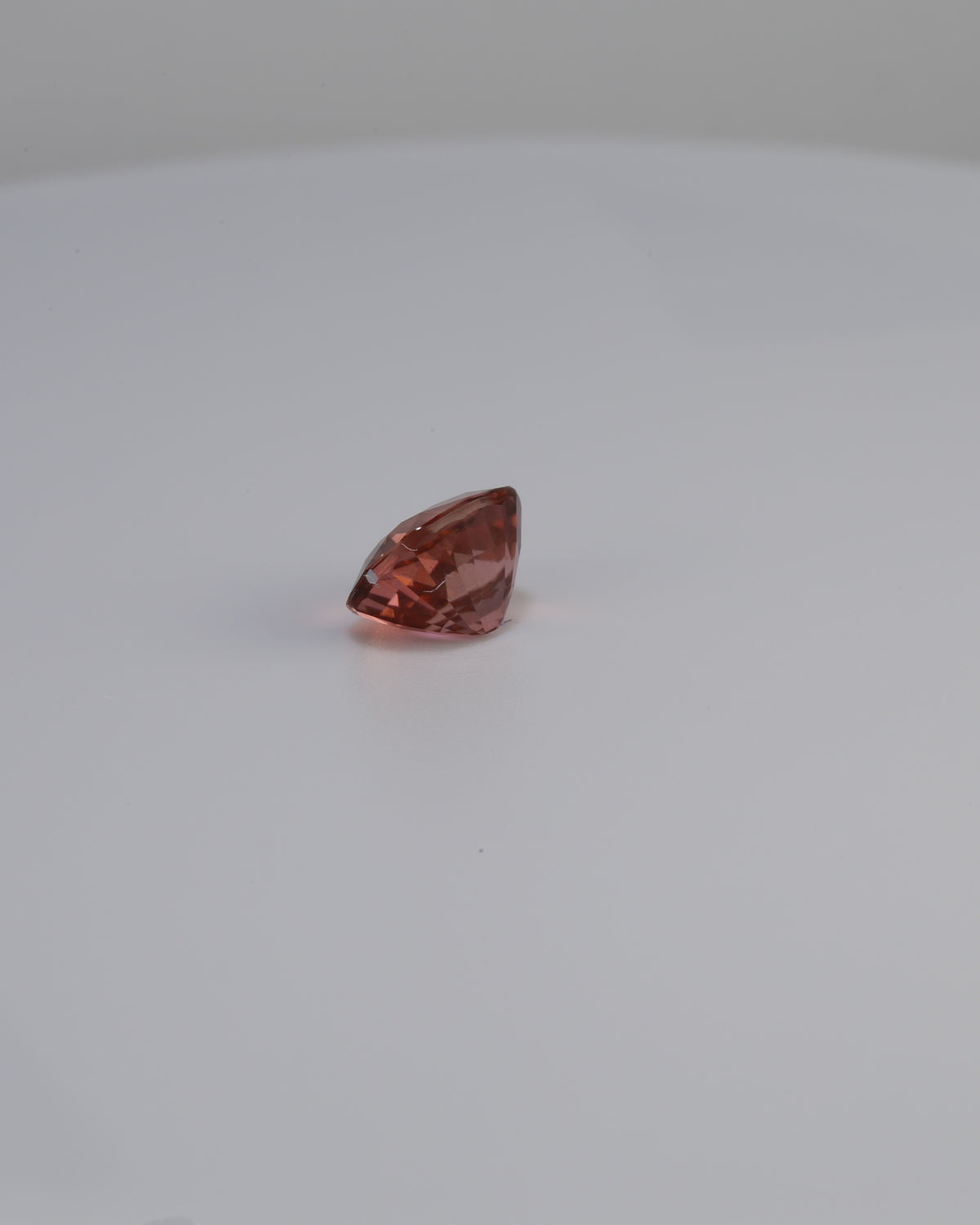 Pinkish peach tourmaline gemstone, 1.42 carats, portrait angle view