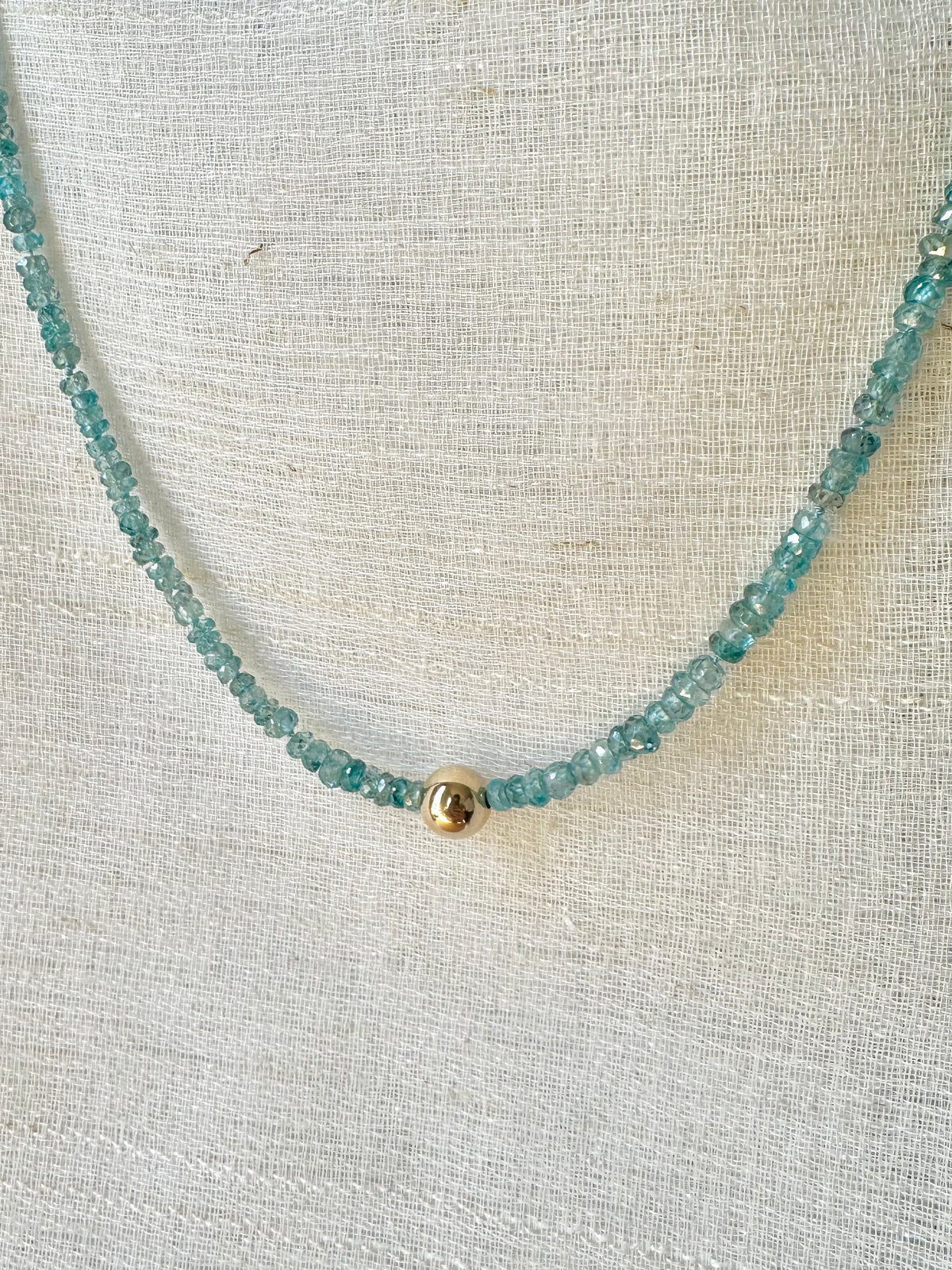Hand-knotted blue zircon beaded necklace with a solid gold center bead | Yasmin Nabulsi Fine Jewelry