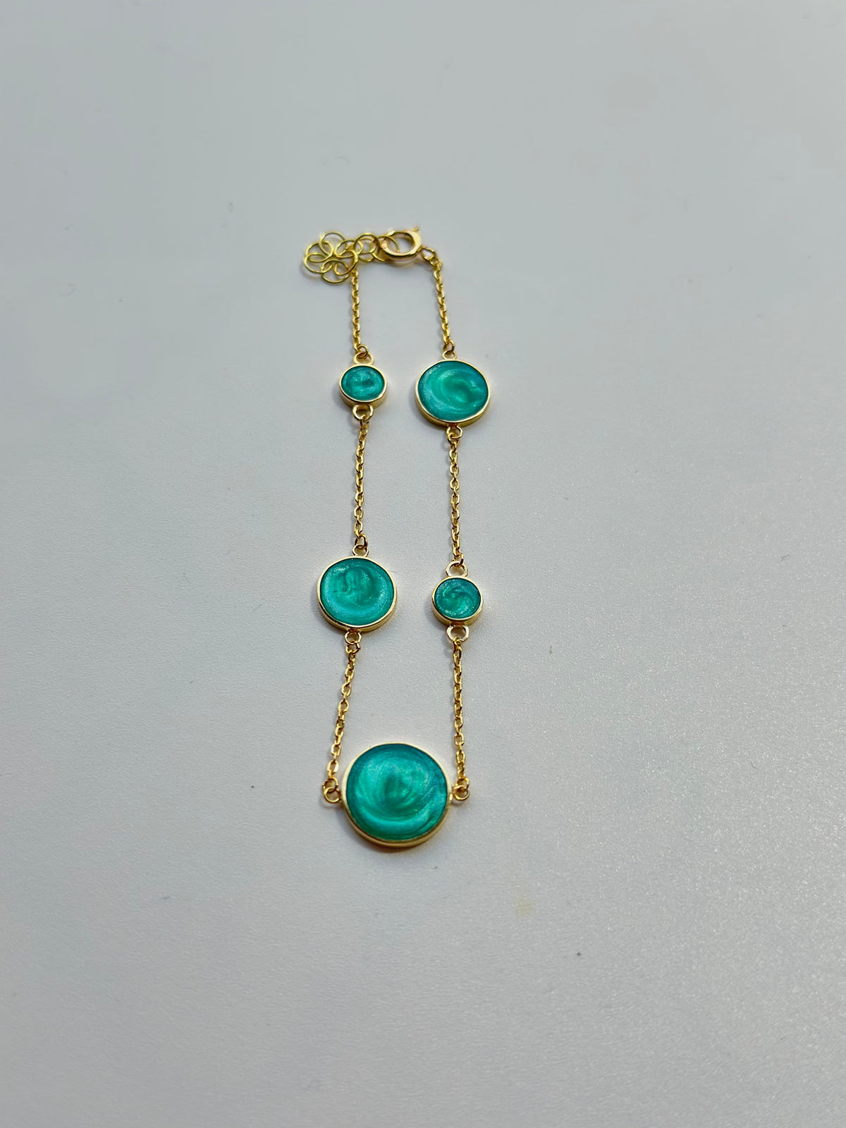 Adjustable 18K gold circles bracelet with a chain extender, fifth view