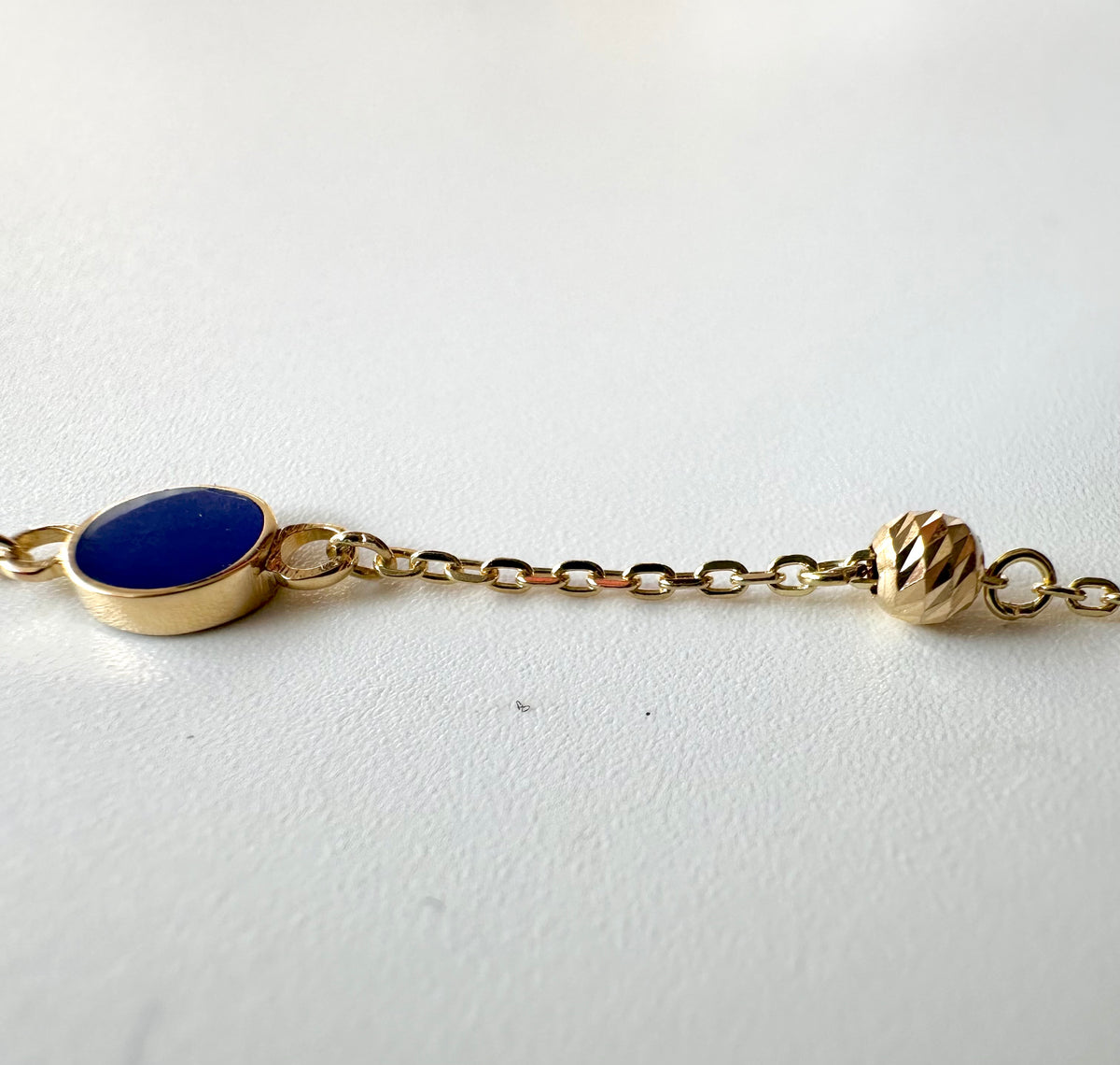 Enamel circles and gold beads on a dainty 18K gold chain, third view