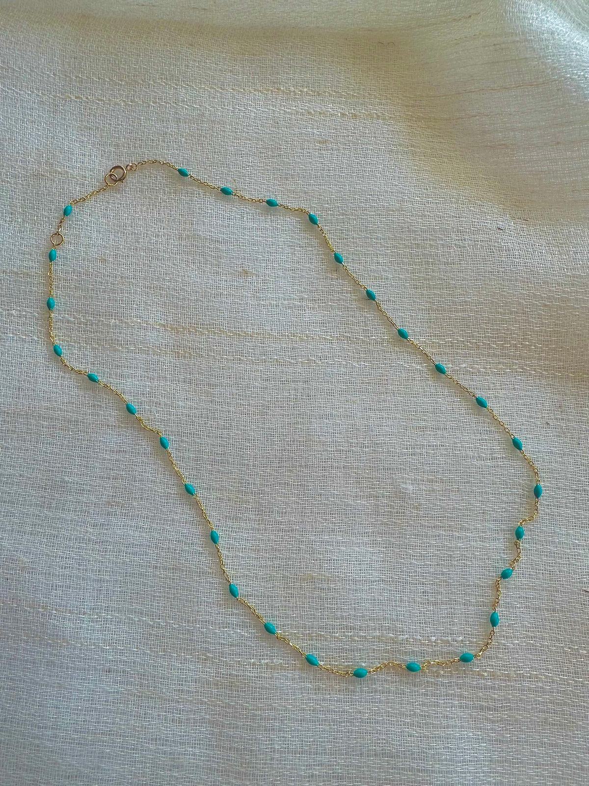 Solid 18K gold enamel bead chain necklace, shown worn layered