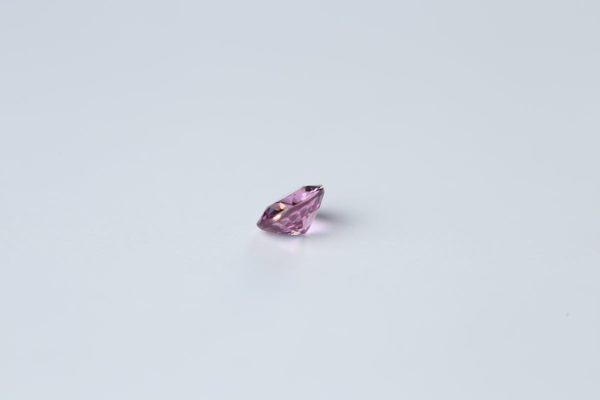 Cushion cut pink sapphire gemstone weighing 0.74 carats, listed as unheated
