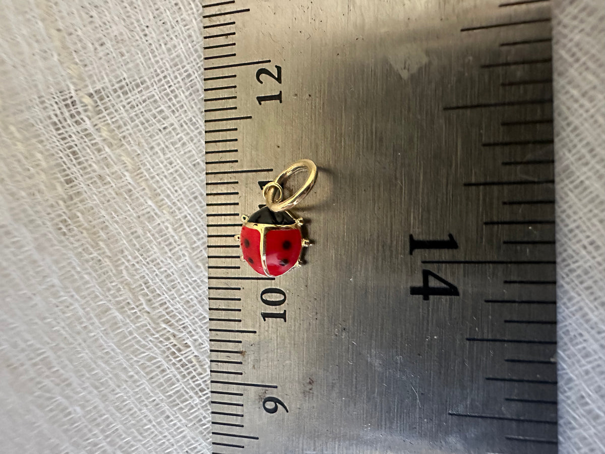 Ladybug charm in 18K gold, made to wear on a chain, hoop, or bracelet