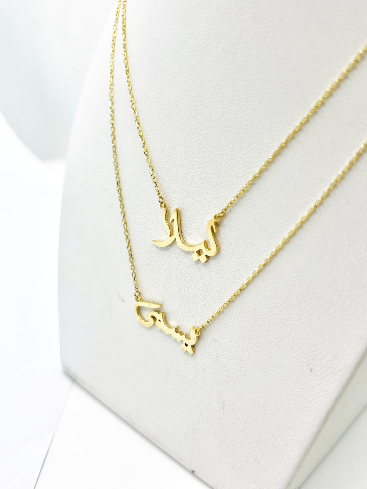 Arabic name necklace with bezel-set diamond dots in 18K gold