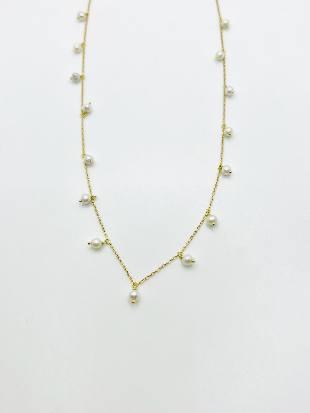 Freshwater pearls suspended from a solid 18K yellow gold station chain