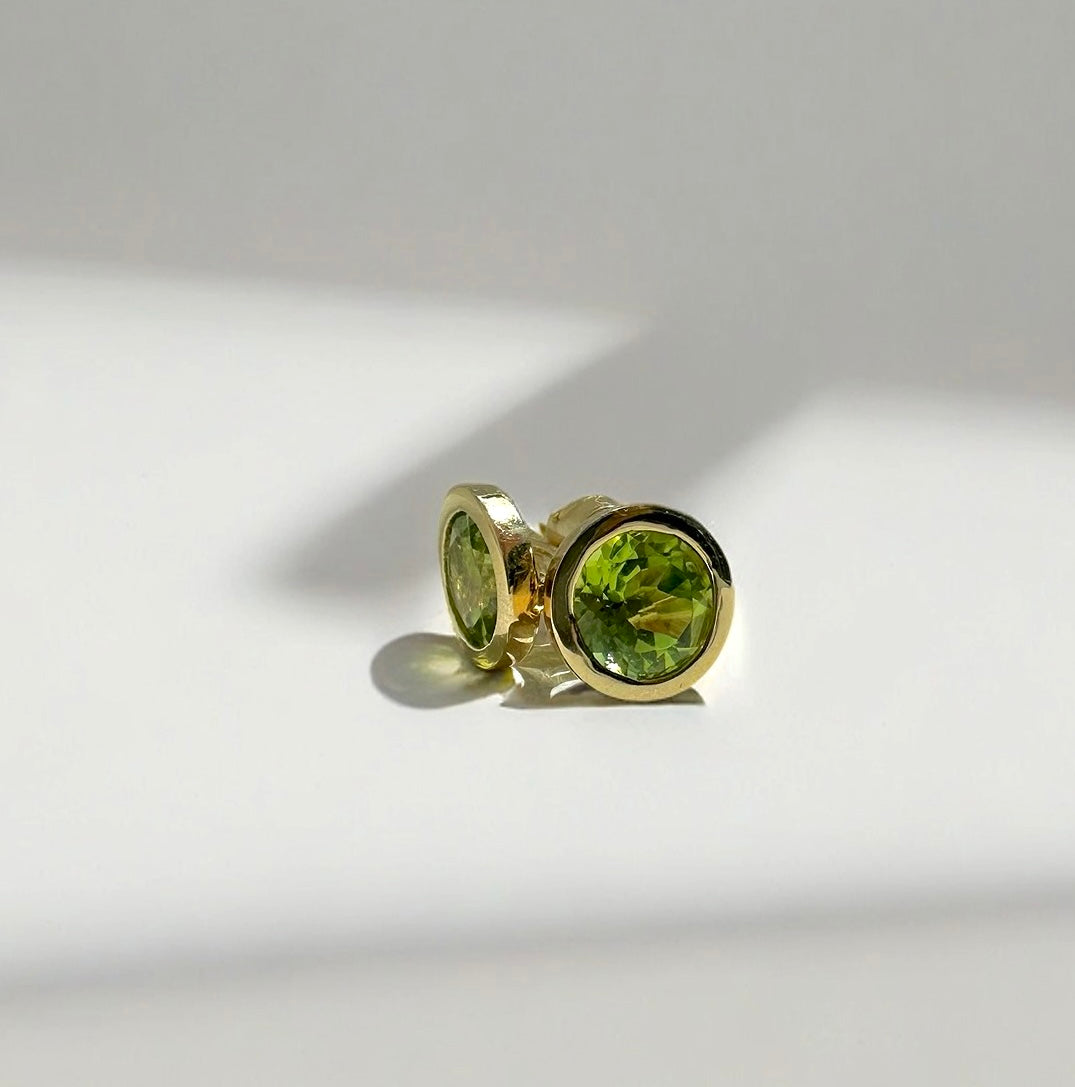 Natural peridot stud earrings in an 18K yellow gold bezel, round and polished | Yasmin Nabulsi Fine Jewelry
