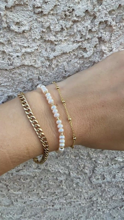 Gold Ball Bracelet featuring gold beads strung seamlessly on a delicate chain.

This Simple Gold bracelet is perfect for a minimalistic stand alone look or for stacking with other bracelets.