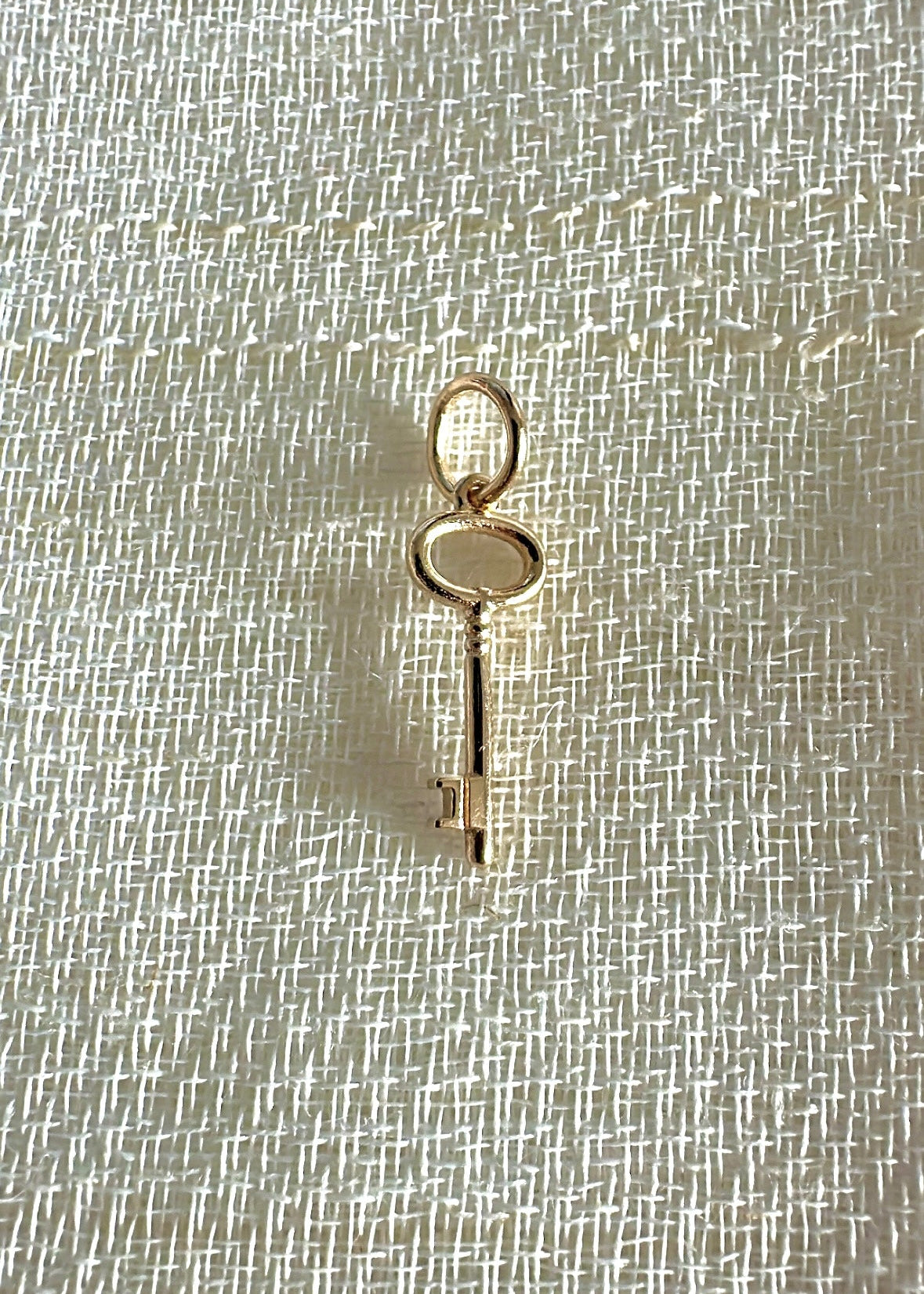 Gold key charm, alternate view