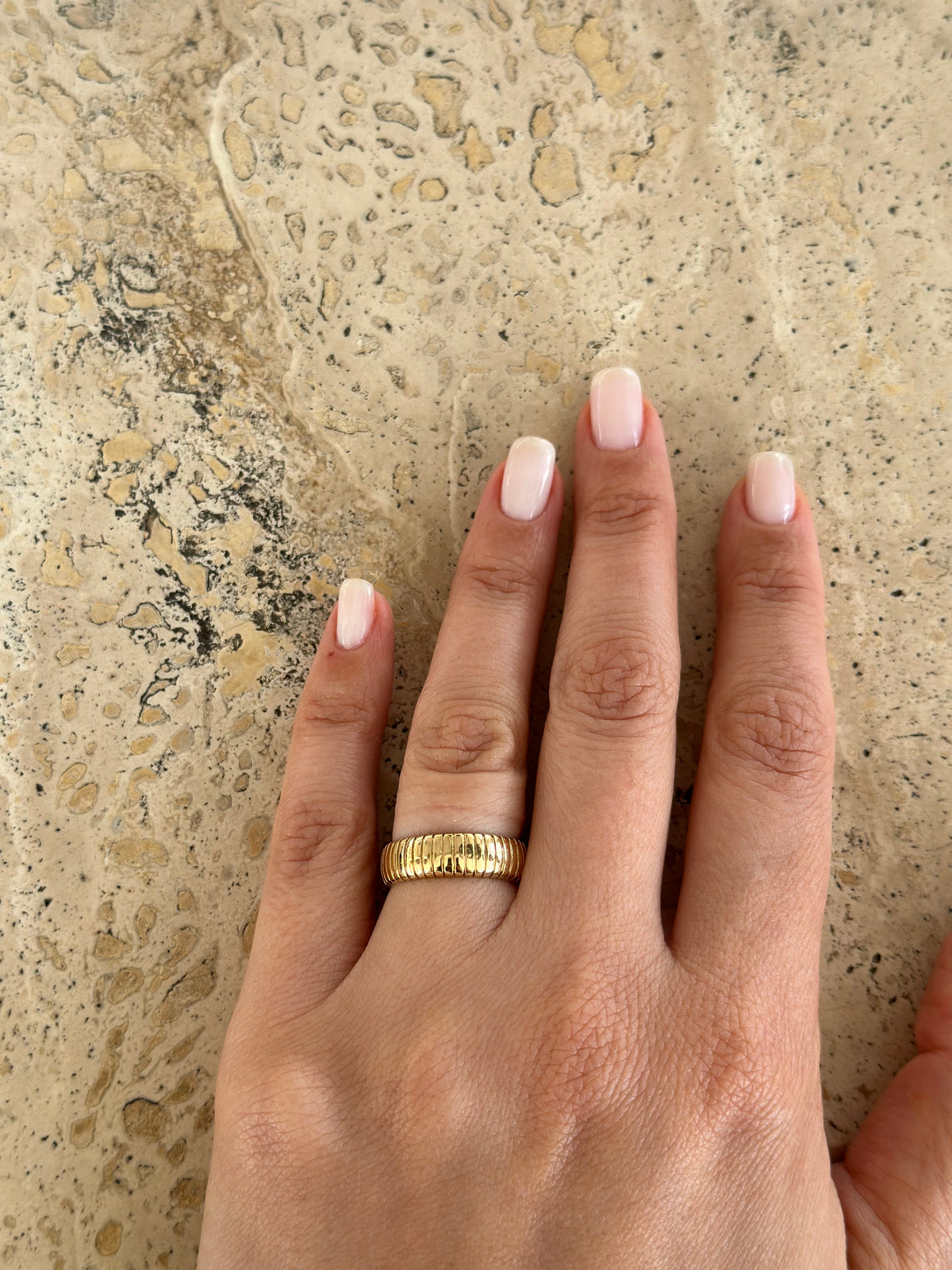 Thick gold band with a ribbed surface, offered in US sizes 4 to 8 1/2