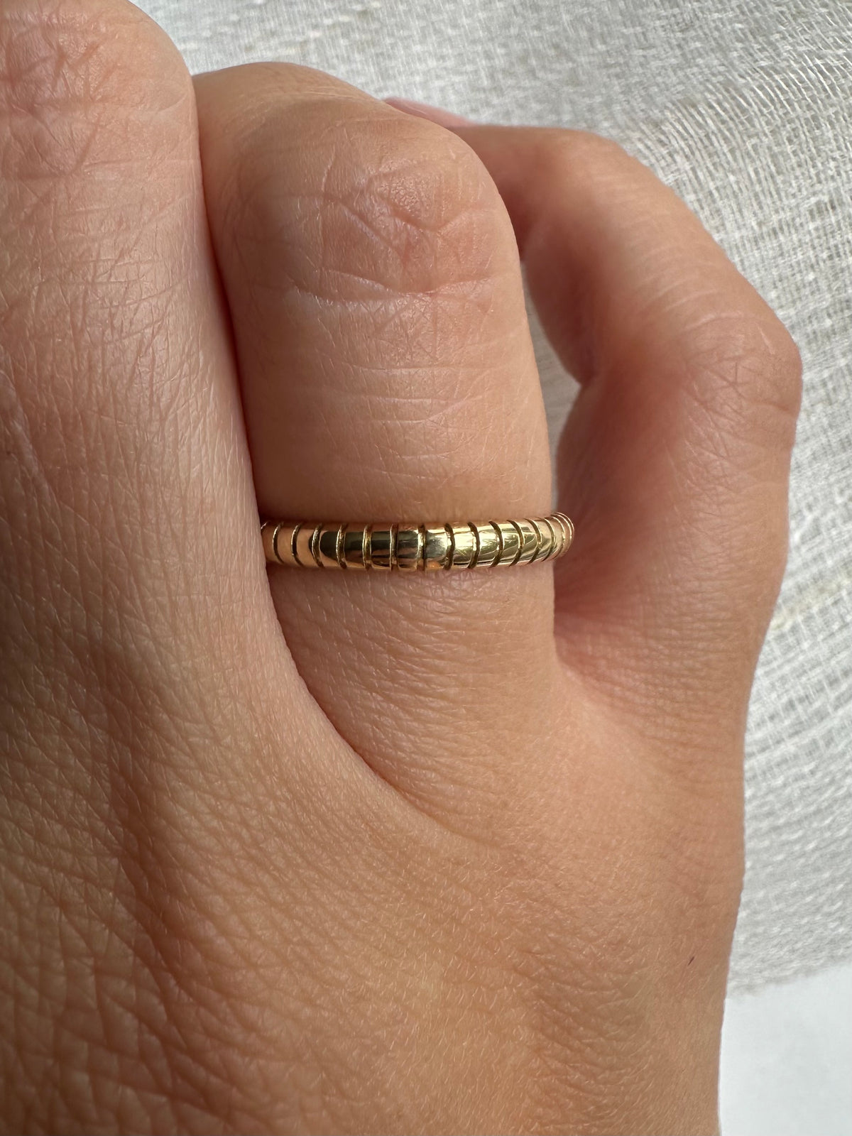 Thin gold ring with a polished ribbed texture, 2.4mm band width