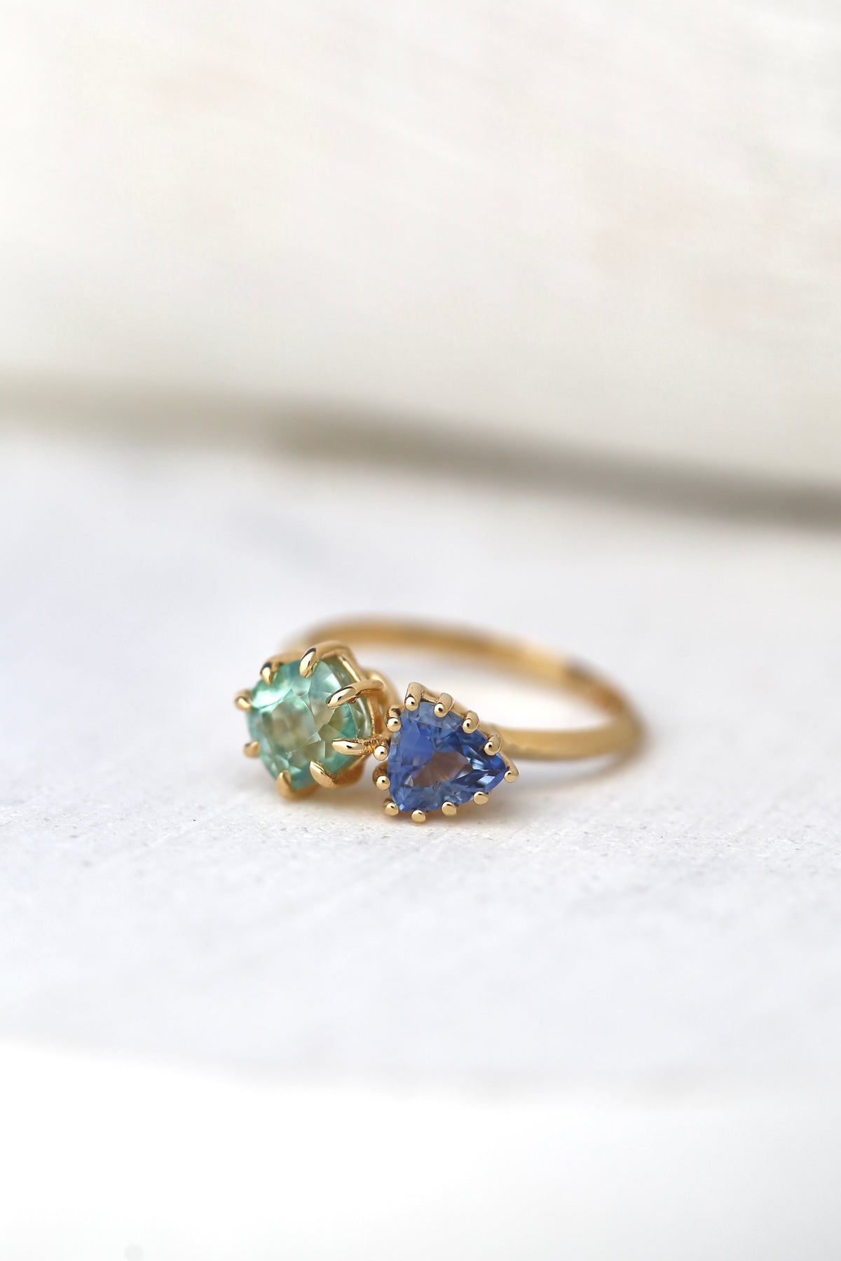 Toi et Moi ring with a blue sapphire in a classic round prong setting