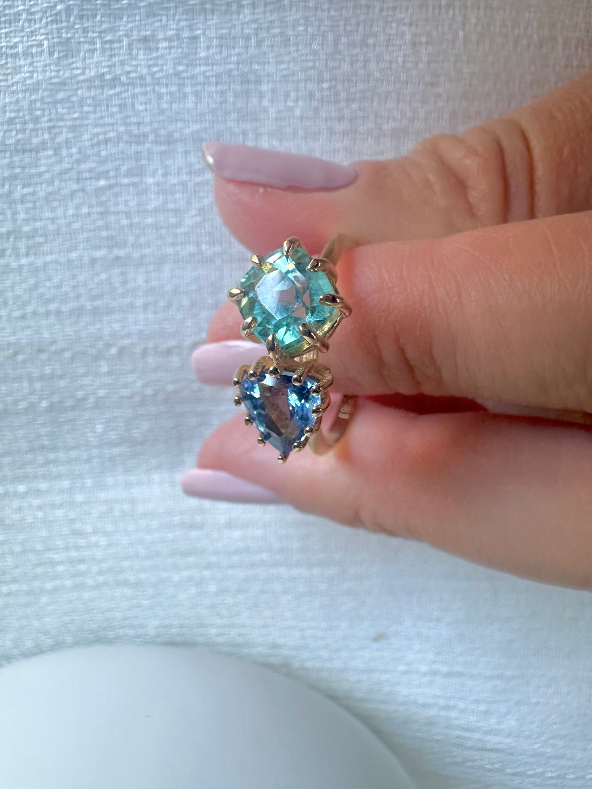 Toi et Moi ring with a cushion-cut tourmaline and triangular sapphire, both set in 18K gold