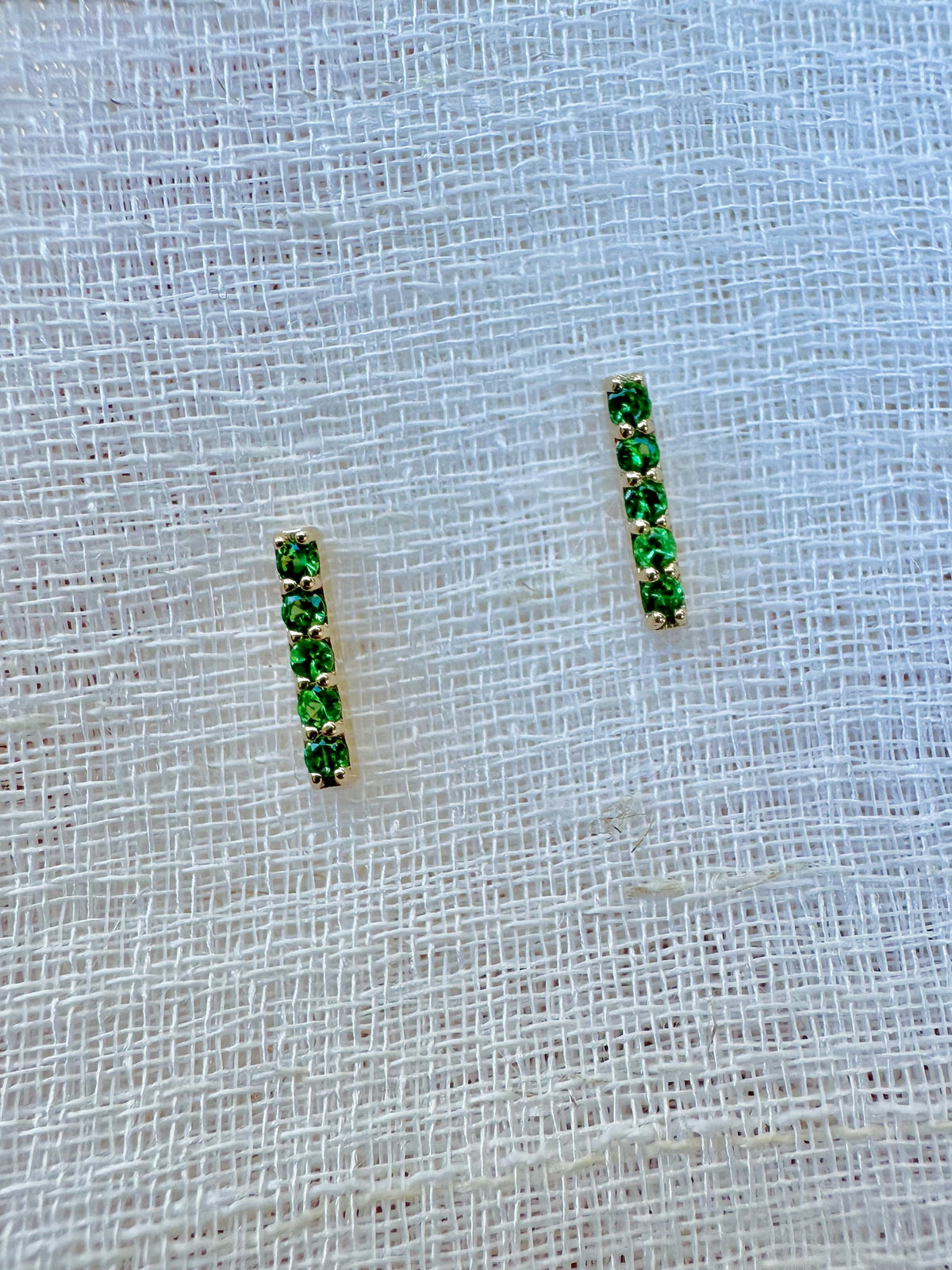 Linear 18K gold bar studs with a friction back closure