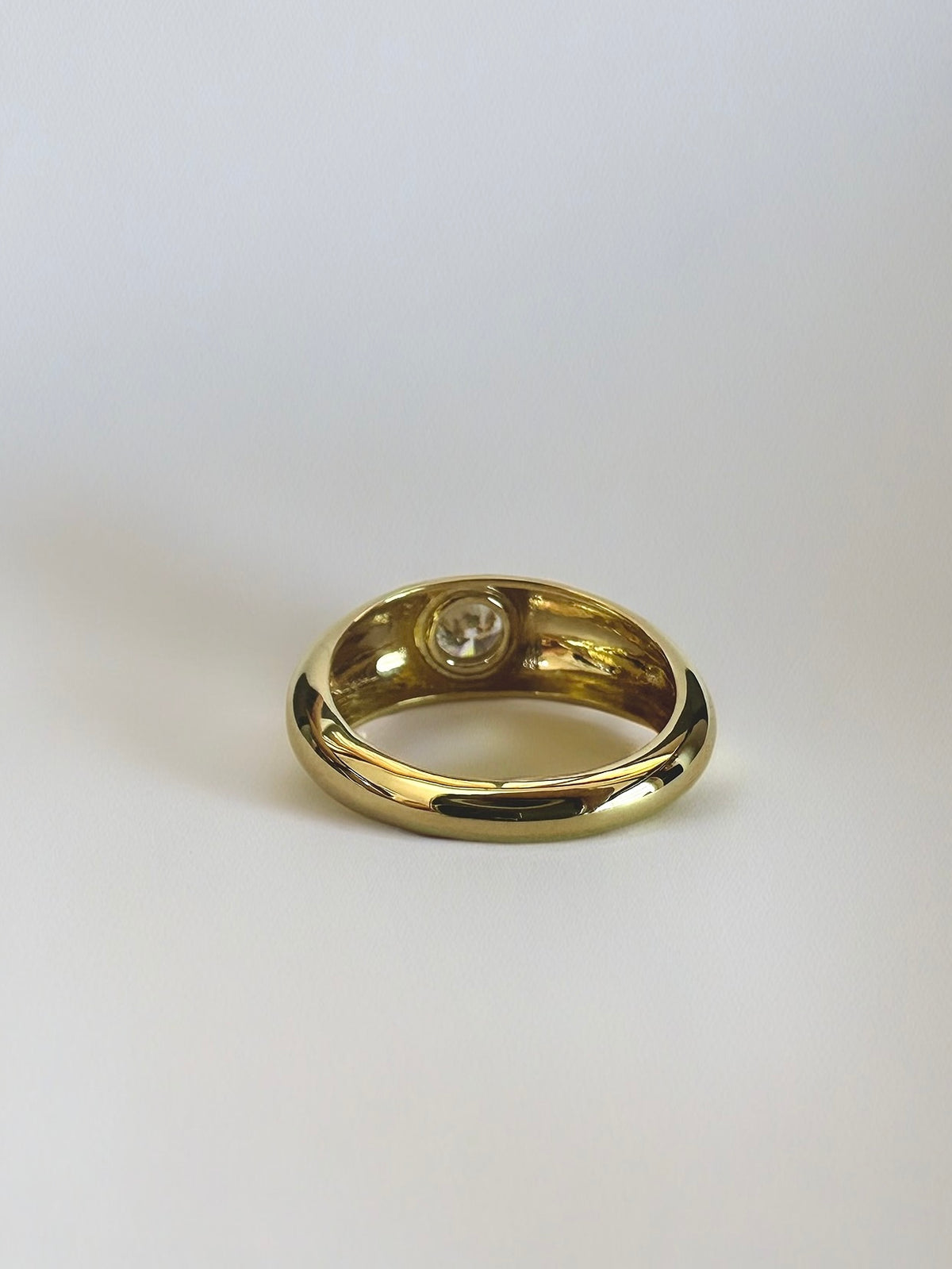 Wide 18K gold dome ring with a flush-set lab diamond
